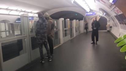 Paris Metro scene, featuring a man dressed in a camouflage sports outfit.